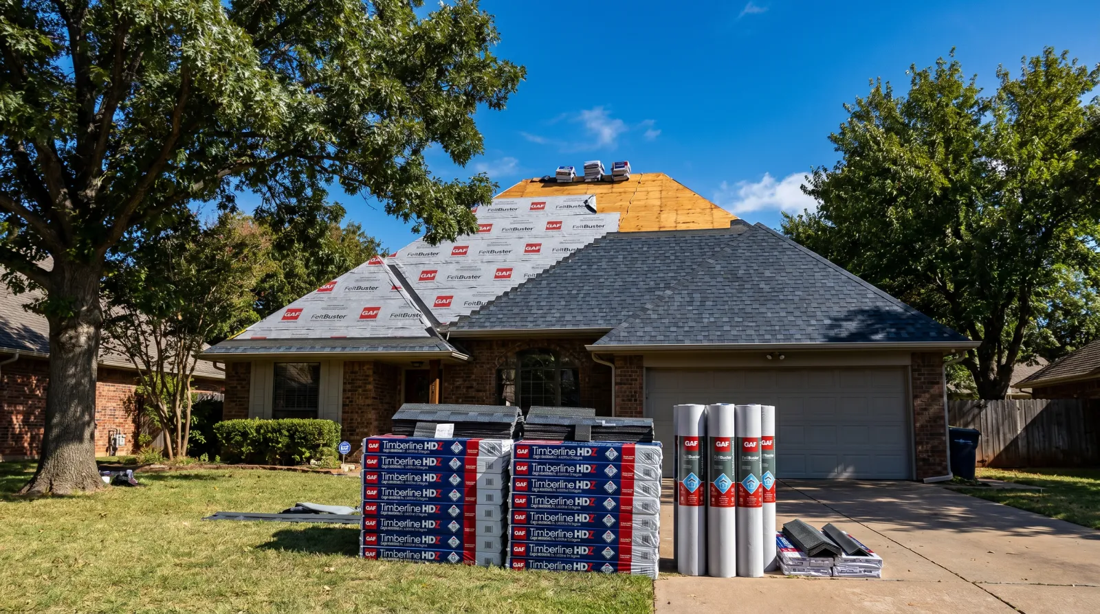 Full architectural-shingle roof replacement on an Oklahoma home with fresh decking and underlayment exposed